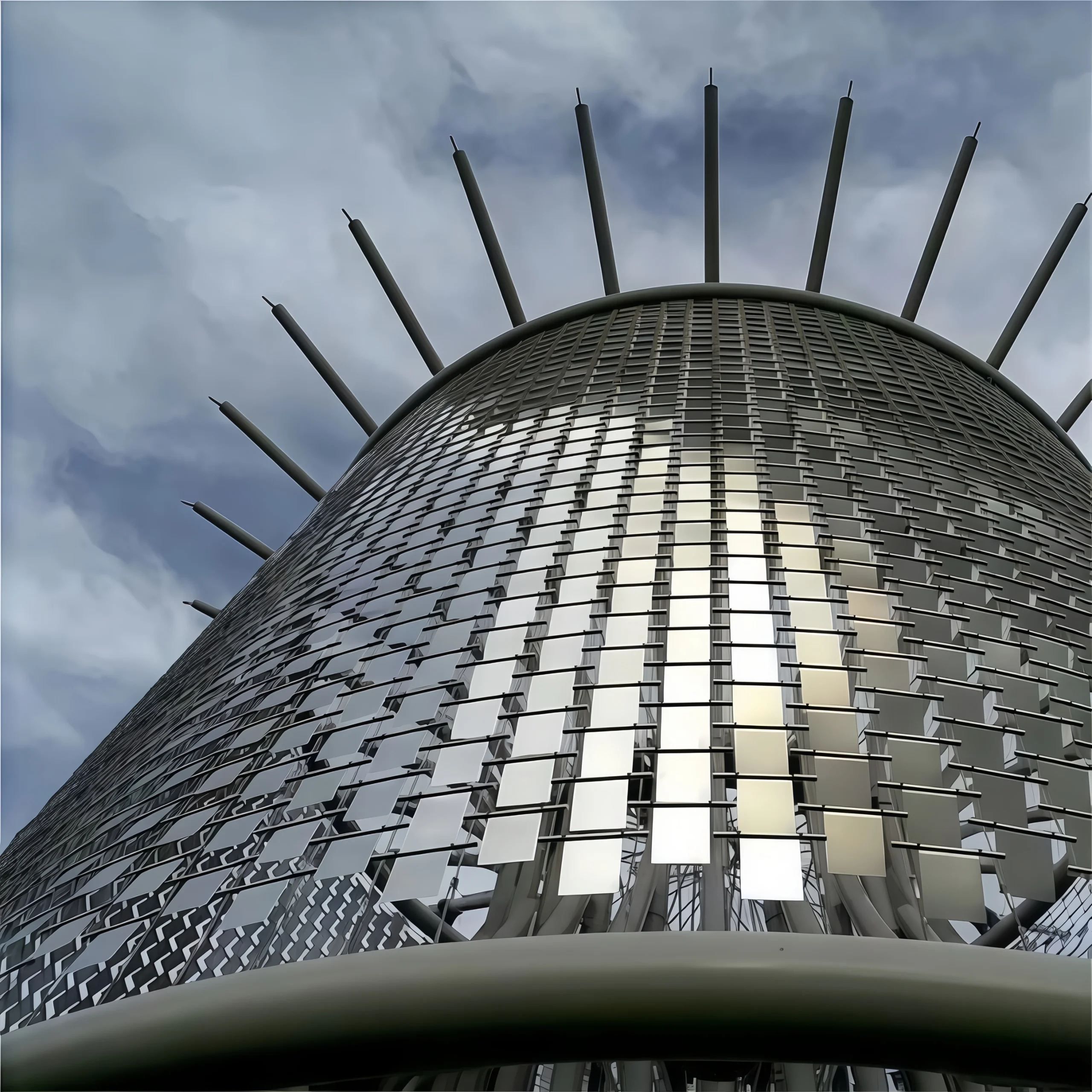 Installation of a stainless steel kinetic wall using high-strength fasteners and turnbuckles for structural stability.